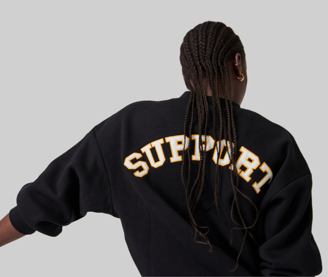 Young Woman wearing a sweater with the word "SUPPORT"